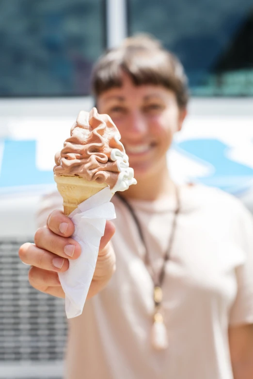 a smiling man holding an ice cream cone