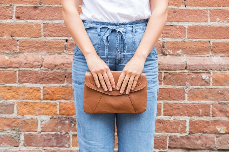 a person with a small purse standing on the street