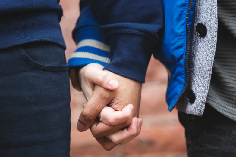 a close up of a person holding another persons hand