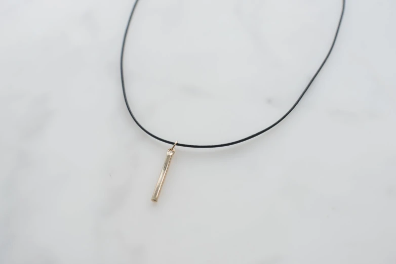 a minimal necklace with a bar charm