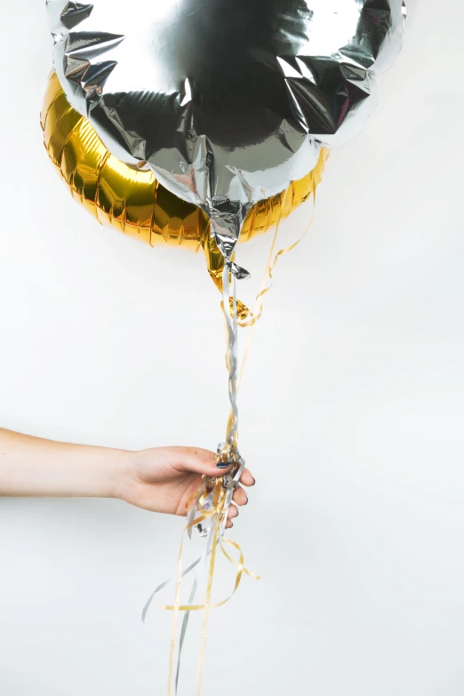 the gold balloon has been tied to the strings