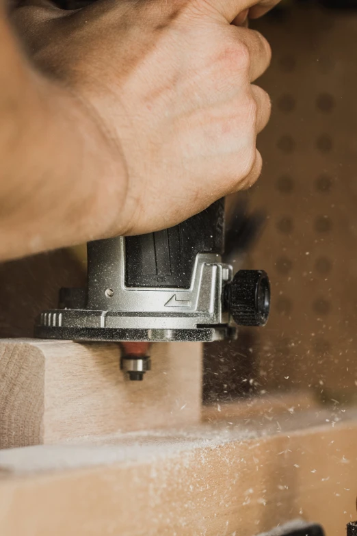 a person working on soing with a piece of metal