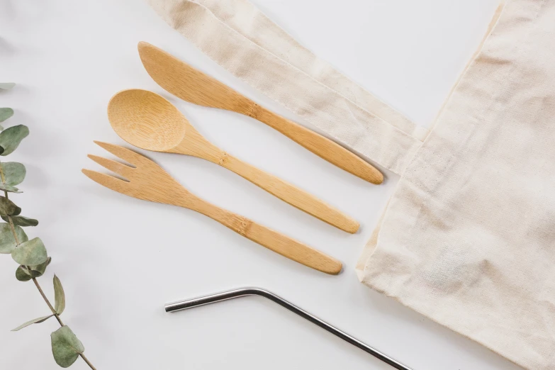 five wooden spoons, one with two of them sitting next to a cloth