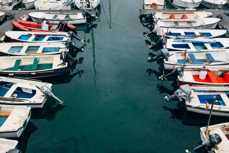 a dock filled with boats parked next to each other