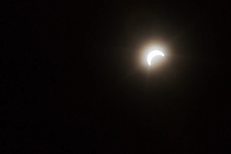 the moon is seen partially eclipse as it passes behind the sun