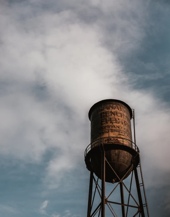 an old fashioned water tower is against the sky