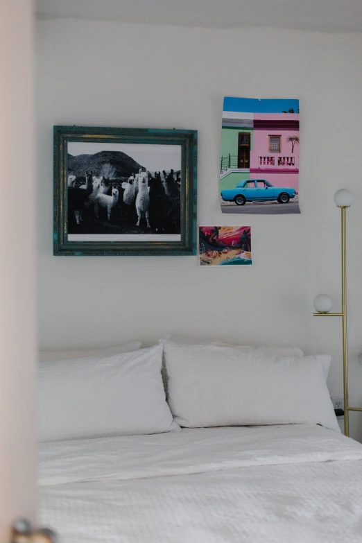 two framed pictures and a bed in a room