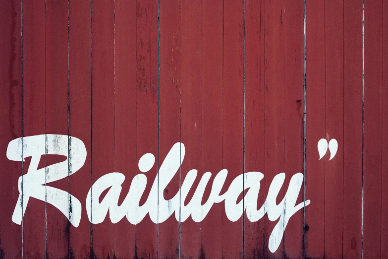 a sign that says railway in large letters on a red background