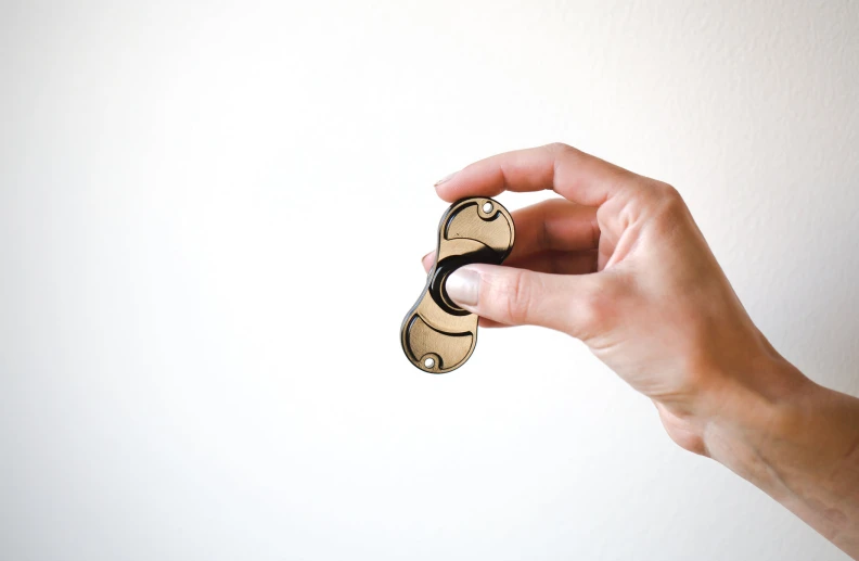 a person holding a small wooden object in one hand