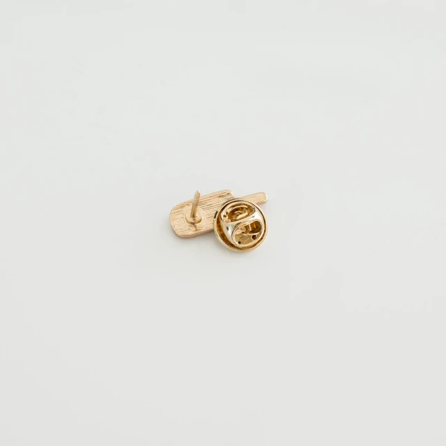 a gold ring sits on a white background