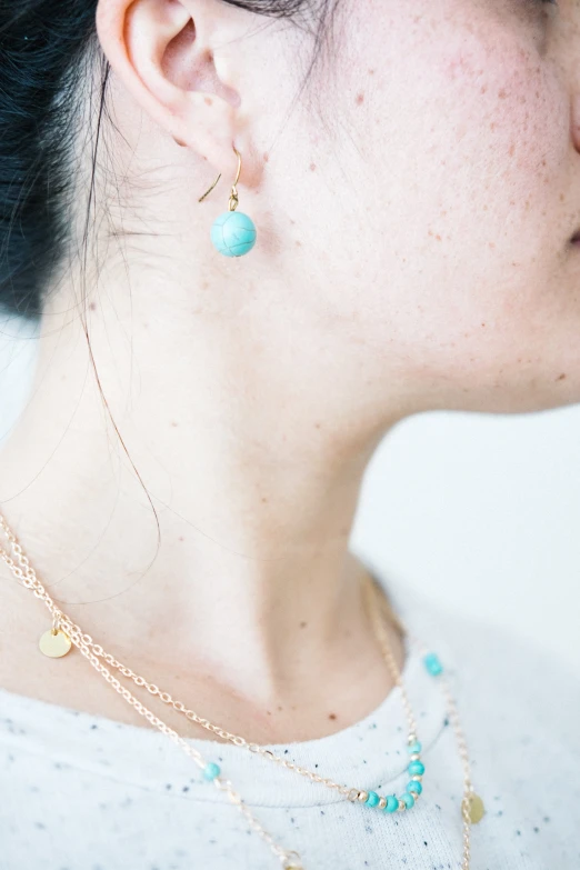 a close up s of a woman wearing some type of necklace