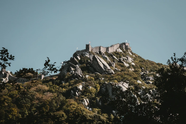 a very tall rock outcropping with a big castle on top