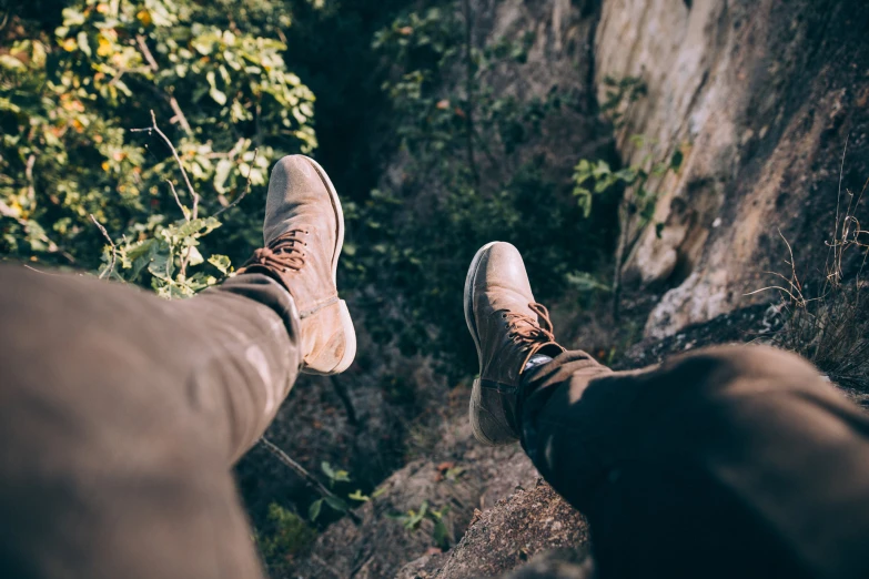 there are two men on a steep cliff