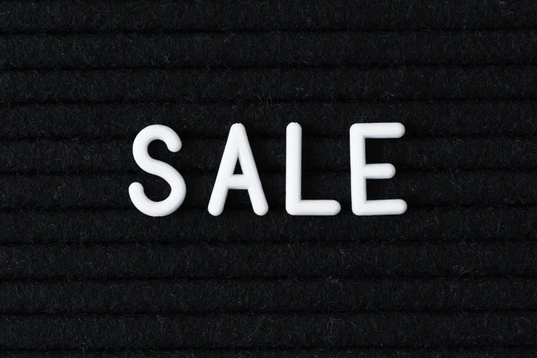 a black background with a white letters sale