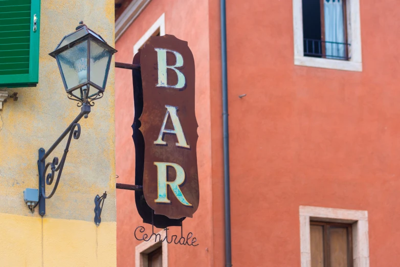 a restaurant sign in front of an orange building