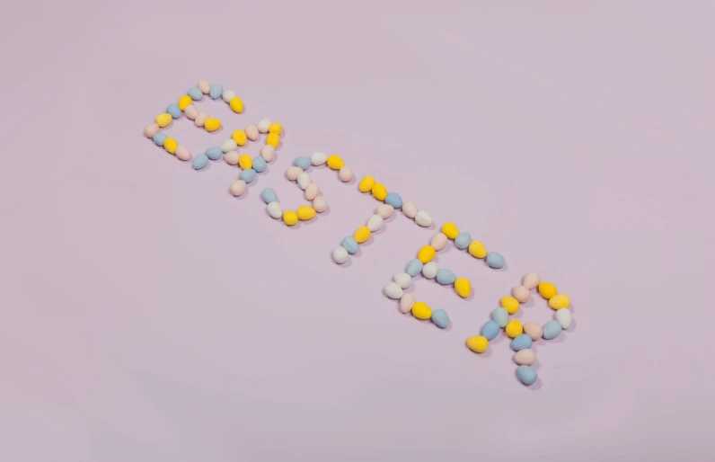 pills spelling out the word'birth'with purple background