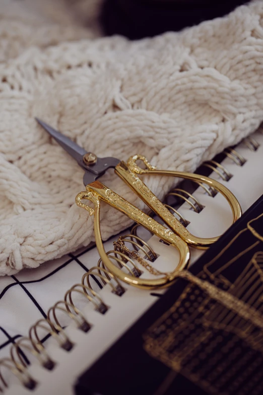 a knit blanket and scissors on a table