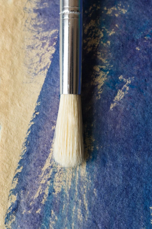 a blue brush is shown on a blue cloth