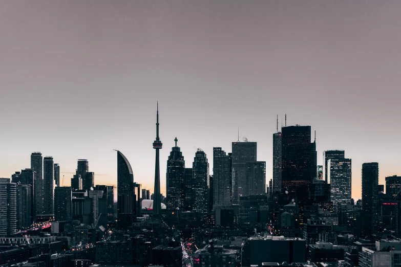 city skyline with cars and lights at sunset