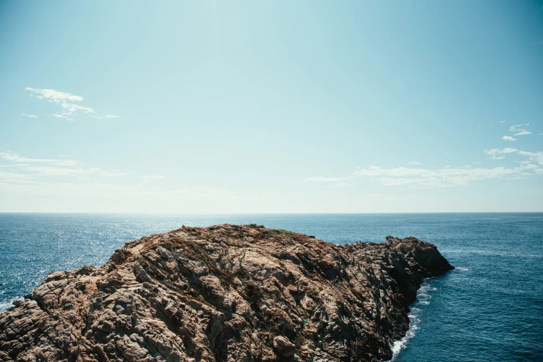 a rock that is sitting in the middle of the ocean