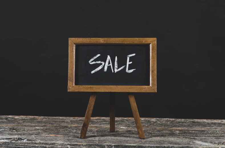 an old wooden stand with a chalk board