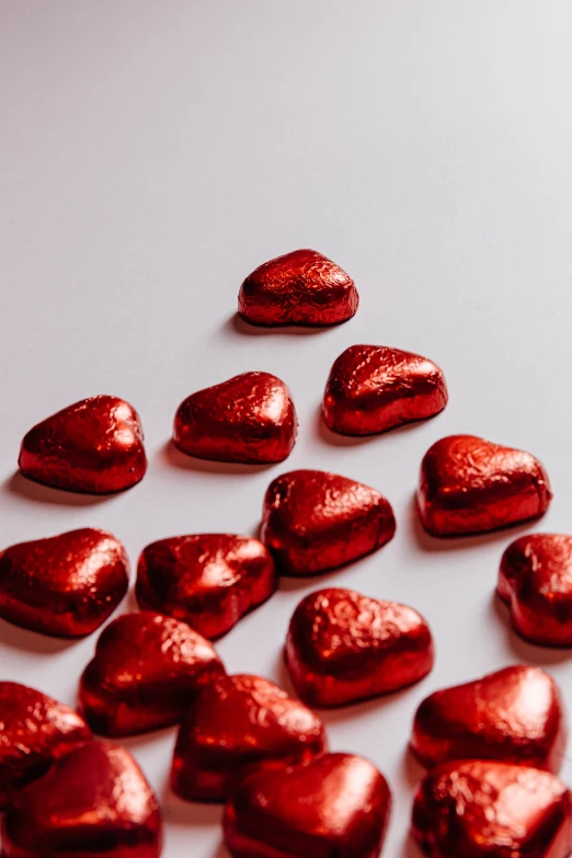 some red heart shaped candies laying on top of each other