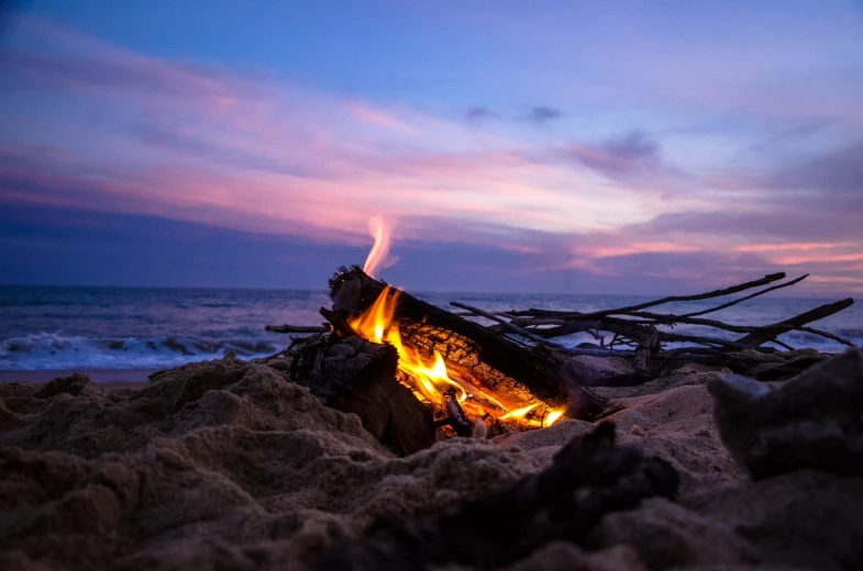 a fire pit is sitting in the sand