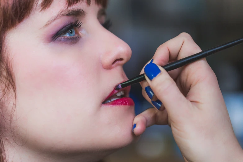 the woman is getting ready to brush her lips