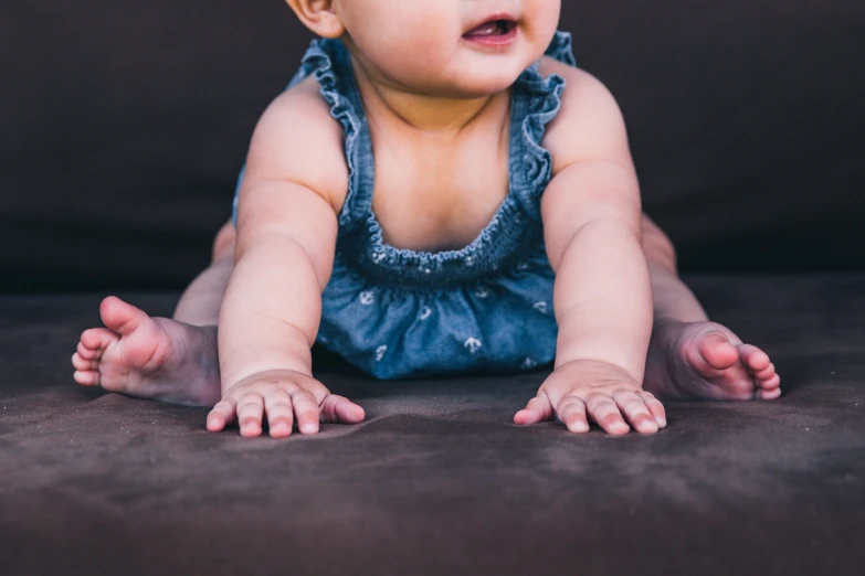 a baby with hair in it laying on its back