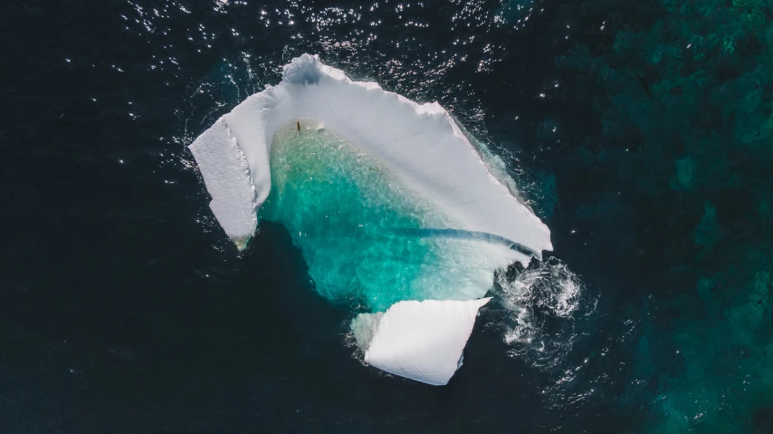 an iceberg is floating in the water on the ocean