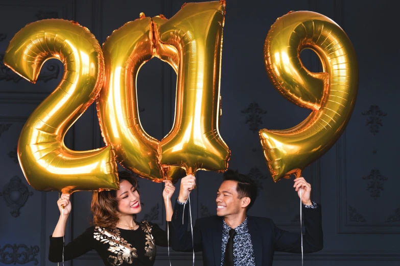 an image of two people holding numbers that say'2019 '