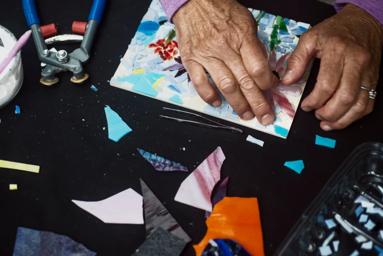 a person painting with different kinds of scissors