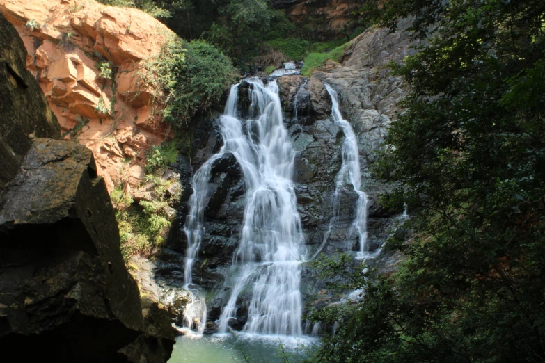 a large waterfall flowing into the woods