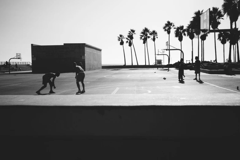 two men on skateboards in a parking lot