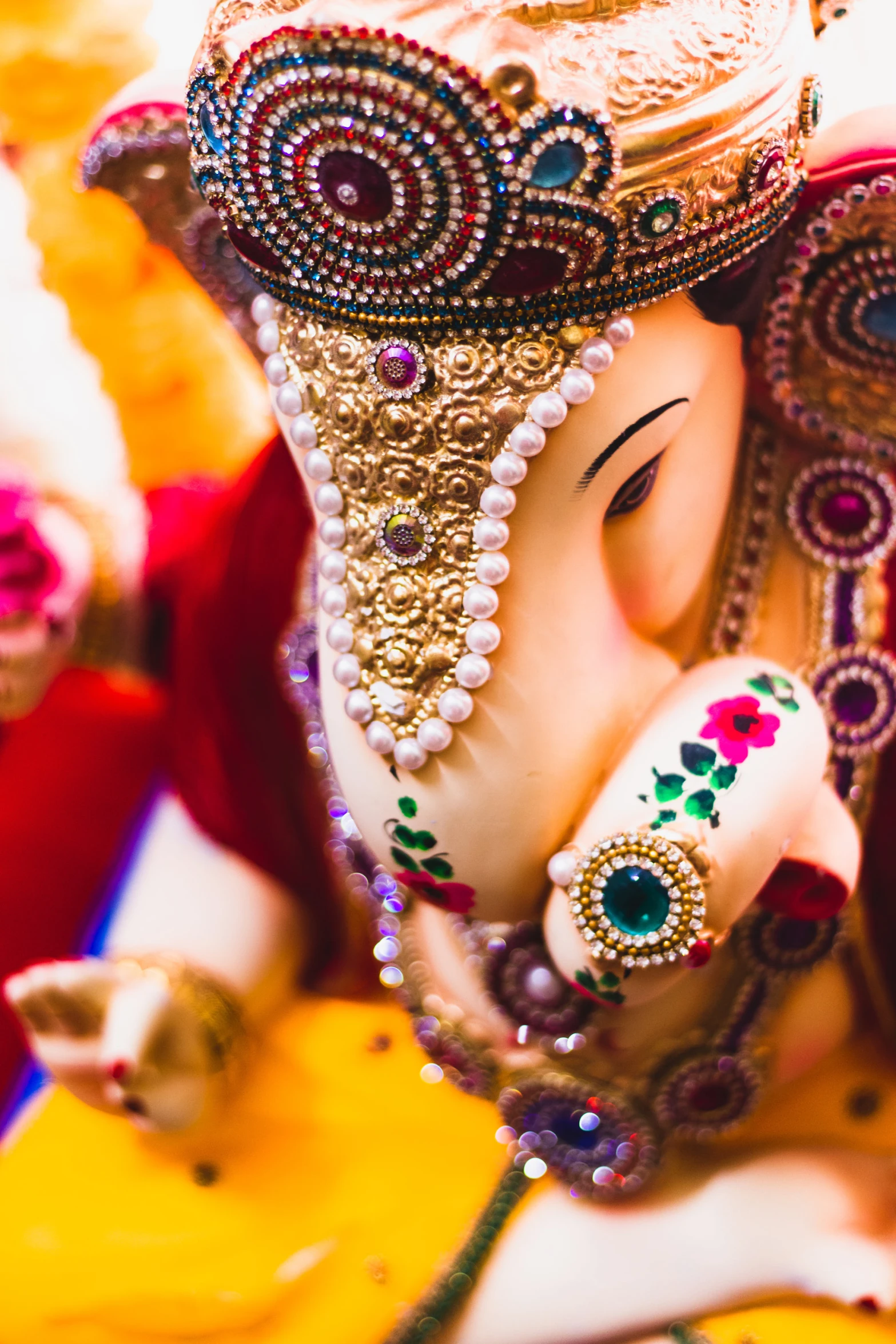 a close up of an elephant with decorations on its head