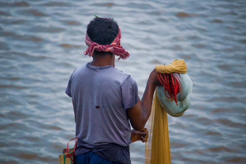 a man and woman standing on a dock near a body of water