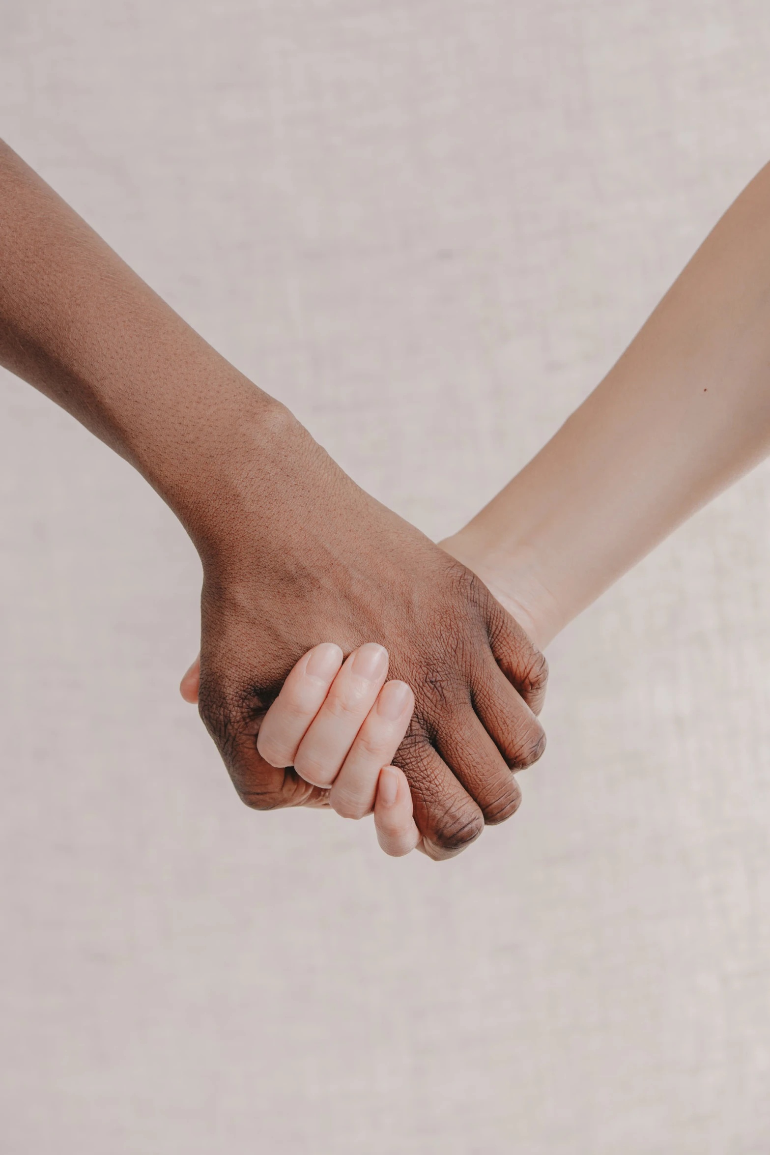 two people holding hands with both hands extended