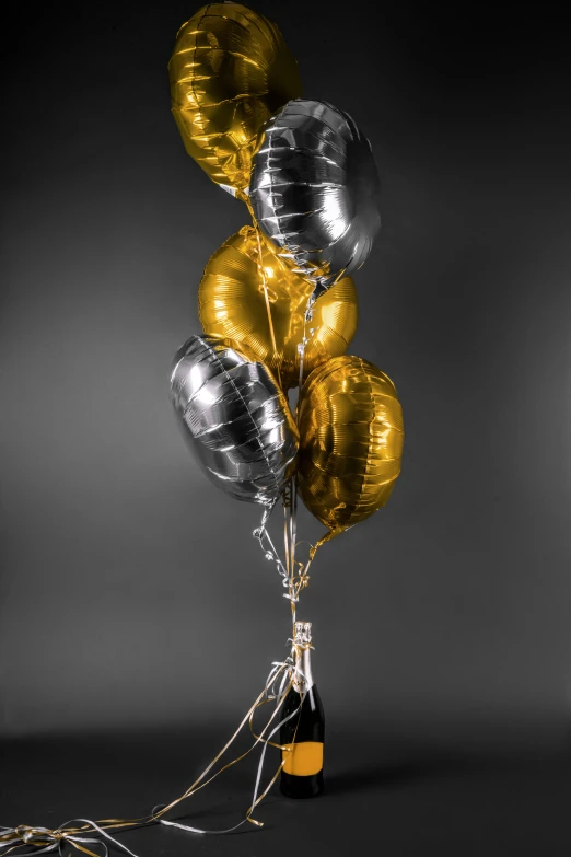 black and white pograph of silver, gold and metallic balloons