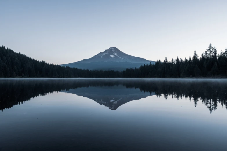 a large mountain with trees on both sides