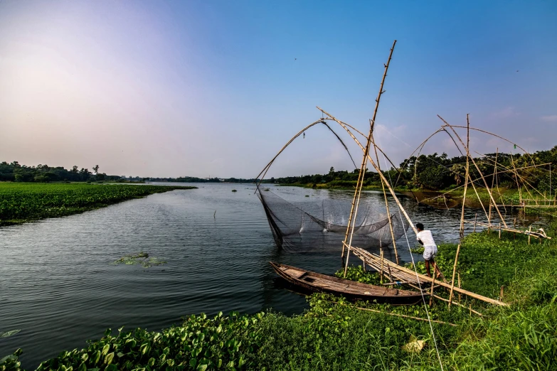 a man is standing next to his boat