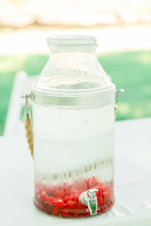 a red and white drink in a glass container