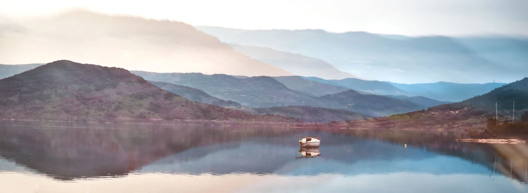 mountains are seen behind a body of water