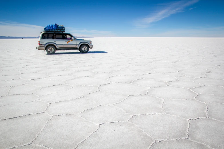 a van with luggage on it and in the middle of nowhere