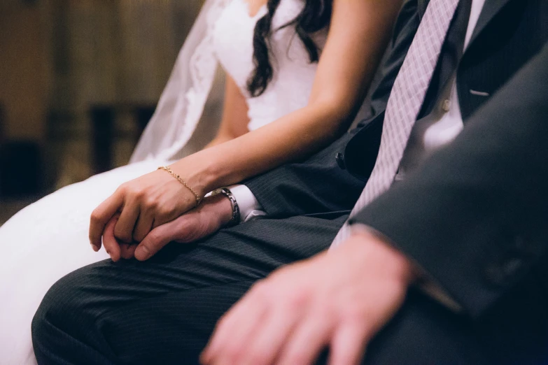 man and woman on white chair at wedding