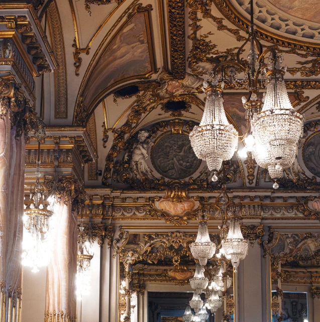 the ornate building has chandeliers hanging from it