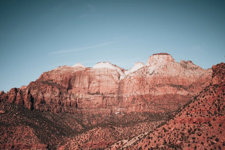 red rock mountains surround a cloudless sky