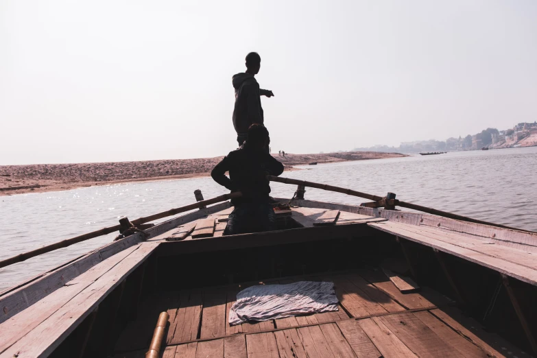 a person standing at the end of a boat