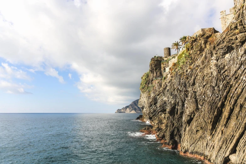 a rocky shoreline with houses in the water