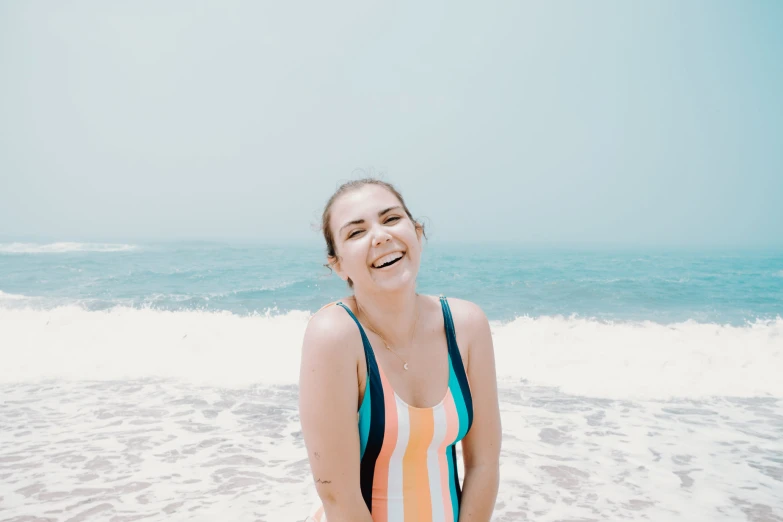 a woman standing in the water at the beach