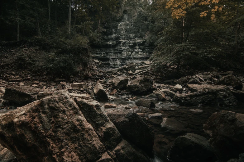 a large rock in a narrow ravine filled with water